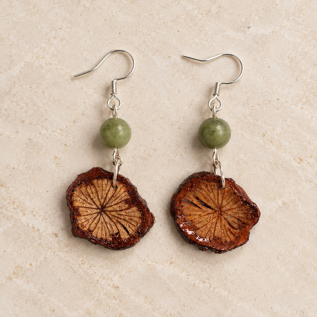 DU20 Da Xue Teng herbal-inspired earring pair on a neutral background